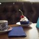 Cupcake and coffee on restaurant table with QR code for payment